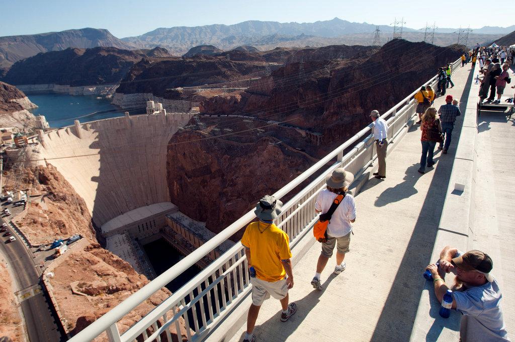 People walking on the Bridge looking at the Hoover Dam